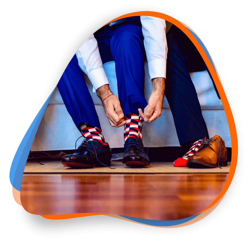 A man tying his shoes on the floor