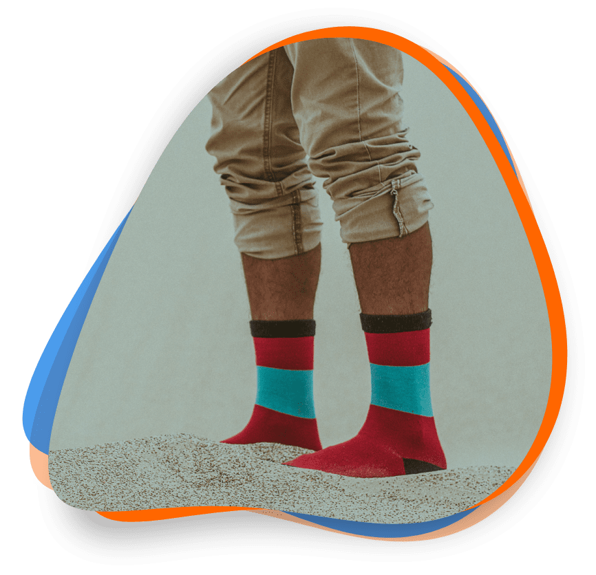 A person wearing red, blue and black socks.